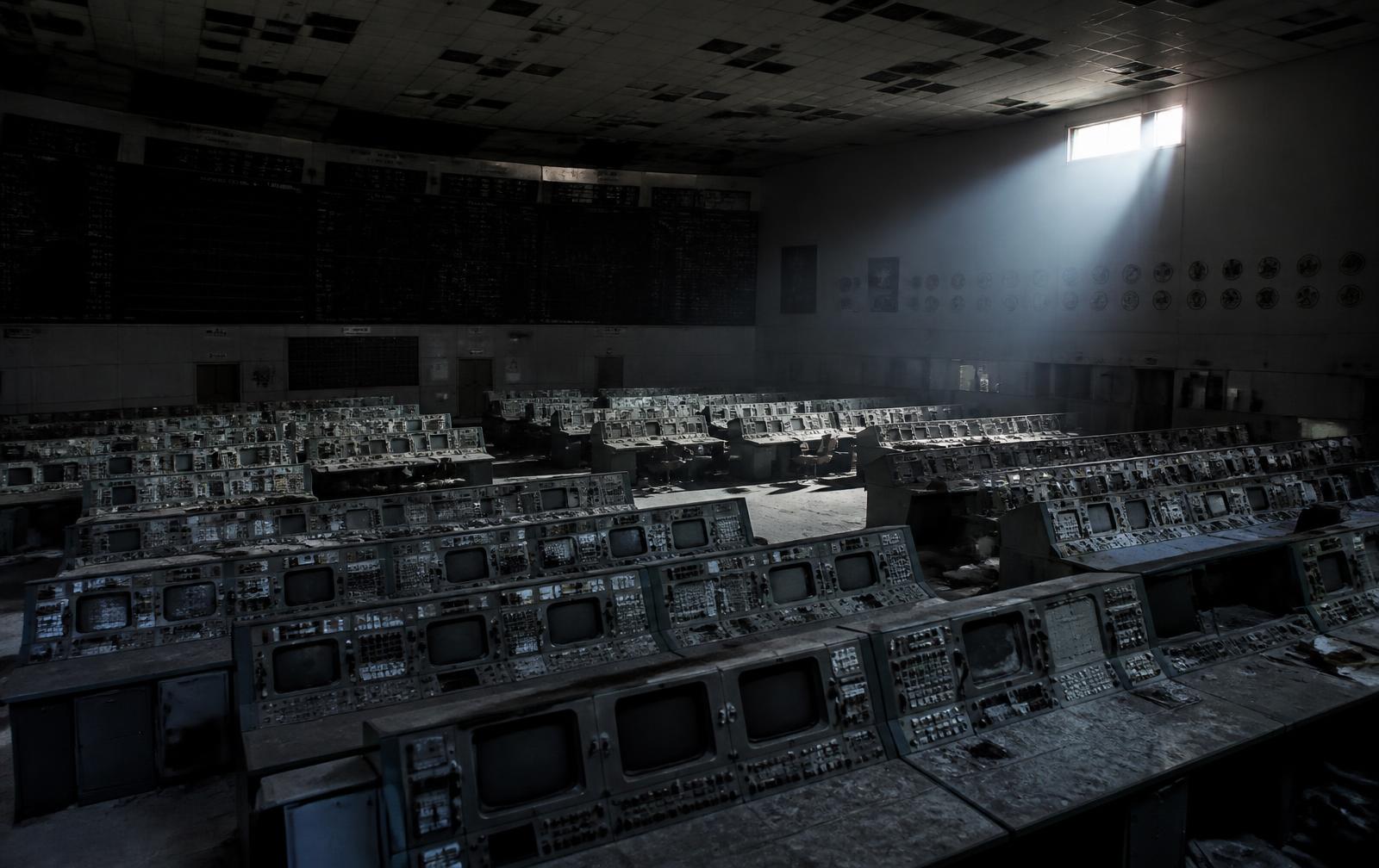 An abandoned control room full of dead monitors